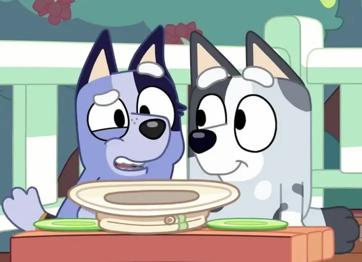 The character Socks (left) from the show Bluey in an episode.