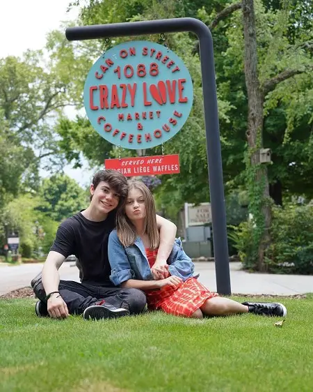 Sophie Fergi with her ex-boyfriend Jentzen Ramirez below a sign that says 'Crazy Love'.